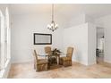 Dining room featuring a glass-top table, travertine floors, and elegant chandelier at 836 Copperfield Ter, Casselberry, FL 32707