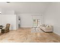 Bright living room featuring beautiful tile floors and a sliding glass door at 836 Copperfield Ter, Casselberry, FL 32707
