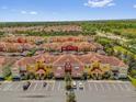 Expansive aerial shot of vibrant townhomes with red roofs and lush landscaping at 8972 Coco Palm Rd, Kissimmee, FL 34747