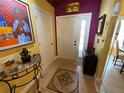 Warm foyer featuring a tiled floor, decorative mosaic inlay, and an eclectic array of art and decor at 913 Red Fox Rd, Altamonte Springs, FL 32714