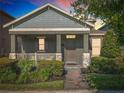 Home featuring a welcoming porch, a well manicured yard, and a cozy facade at 9432 Komika Ln, Winter Garden, FL 34787