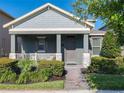 Charming single-story home featuring a cozy front porch and well-maintained landscaping at 9432 Komika Ln, Winter Garden, FL 34787