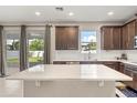 Spacious kitchen with a large island, modern finishes, and a sliding door to the backyard at 1118 Franklin Tree Ln, Sanford, FL 32771