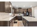 Modern kitchen featuring sleek countertops, stainless steel appliances, and custom dark wood cabinetry at 1118 Franklin Tree Ln, Sanford, FL 32771