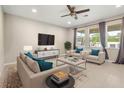 Inviting living room with plush seating, ample natural light, and contemporary decor at 1118 Franklin Tree Ln, Sanford, FL 32771