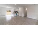 Open-concept living space featuring tile flooring and a modern kitchen with an island at 13 Oak Trail Pl, Ocala, FL 34472