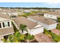 Well-maintained single-story home featuring a brick driveway, attached garage, and blue front door at 1580 Eucalyptus Way, Davenport, FL 33837