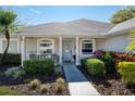 Inviting front porch with blue door, white railing, and meticulous landscaping details at 1624 Malcolm Pointe Dr, Winter Garden, FL 34787