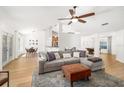 Open-concept living room flows into dining and kitchen with wood-look flooring and neutral tones at 1624 Malcolm Pointe Dr, Winter Garden, FL 34787