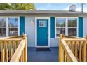 Close-up of front entrance showcasing blue door and new railings at 1900 E Orange Ave, Eustis, FL 32726