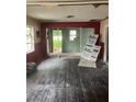 This living room is under construction with exposed framing and unfinished floors; awaiting your personal touch at 1905 S Westmoreland Dr, Orlando, FL 32805