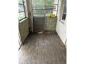 Enclosed sunroom featuring wood-look floors, large windows, and a painted block accent wall, ready for customization at 1905 S Westmoreland Dr, Orlando, FL 32805