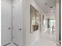Bright hallway featuring tile floors, recessed lighting, and contemporary wall decor at 2334 Lily Bloom Rd, St Cloud, FL 34771