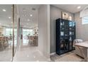 Hallway with tile floors and a view of the kitchen and living area with a built-in cabinet at 2334 Lily Bloom Rd, St Cloud, FL 34771