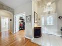 Elegant foyer with wood and tile flooring, leading to living spaces at 2409 Twickingham Ct, Clermont, FL 34711