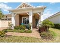 Inviting front porch with decorative columns and blue Adirondack chairs, leading to the front door at 2789 Southland St, St Cloud, FL 34772