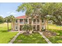 Beautiful two-story townhouse with red tile roof and manicured lawn at 2808 Osprey Cove Pl # 201, Kissimmee, FL 34746