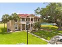 Stunning two-story building with a red tile roof and multiple balconies overlooking lush green spaces at 2808 Osprey Cove Pl # 201, Kissimmee, FL 34746