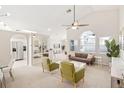 Spacious and bright living room with a ceiling fan and an open design leading to the dining and kitchen areas at 2884 Picadilly Cir, Kissimmee, FL 34747