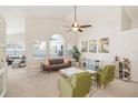 Bright living room features a ceiling fan, large windows, and comfortable seating with stylish decor at 2884 Picadilly Cir, Kissimmee, FL 34747