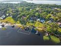 Stunning lakefront estate with a private dock and a sparkling swimming pool nestled amongst lush greenery at 2926 Marquesas Ct, Windermere, FL 34786