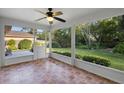 Inviting screened porch with tile flooring, offering serene views of the lush, green backyard and providing shade at 453 Kettering Rd, Deltona, FL 32725