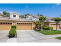 Inviting exterior view showcasing a row of townhomes with well-maintained landscaping and two-car garages at 484 Harbor Winds Ct, Winter Springs, FL 32708