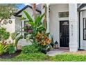 Close-up of the front entrance with meticulously maintained landscaping and black door adding a touch of elegance at 5112 Jetsail Dr, Orlando, FL 32812