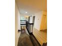 Bright hallway features wood-look floors, access to stairs, and natural light from the windows at 5999 Lake Pointe Dr # 602, Orlando, FL 32822