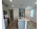 Modern kitchen featuring a large island, stainless steel appliances, and plenty of cabinet space at 6028 Bimini Ave, Haines City, FL 33844