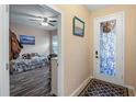 Bright entryway boasts a decorative glass door and a glimpse into the bedroom with modern flooring at 7660 Ripplepointe Way, Windermere, FL 34786