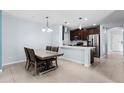 Bright, open-concept kitchen with modern appliances and adjacent dining area at 812 Marcel Loop, Davenport, FL 33837