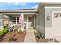 Cozy front porch area with outdoor seating, front door decor, and well-kept landscaping at 8205 Sw 78Th Terrace Rd, Ocala, FL 34476