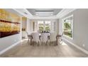 Elegant dining room featuring modern lighting, neutral tones, and large windows at 8638 Finsen St, Orlando, FL 32827