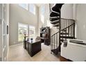 Bright office with spiral staircase, tall windows, and built-in desk at 8638 Finsen St, Orlando, FL 32827