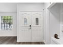 Bright entryway features a stylish white double door with decorative glass inserts and dark wood floors at 1012 Willa Lake Cir, Oviedo, FL 32765