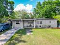 Cozy single-story home with a well-manicured lawn and covered entrance, complete with a private driveway at 106 Alhambra Ave, Altamonte Springs, FL 32714