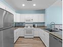 Bright kitchen featuring granite countertops, stainless steel appliances, and white cabinetry at 1322 Seven Eagles Ct # 301, Reunion, FL 34747