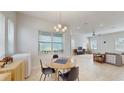 Cozy dining area with a round table, modern lighting, and large windows at 13241 Cormack Ln, Orlando, FL 32827