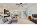 Bright living room with a ceiling fan, wood flooring, and an open floor plan at 13241 Cormack Ln, Orlando, FL 32827