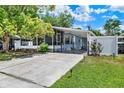 Inviting home with a well-manicured lawn, long driveway, and charming landscaping enhancing curb appeal at 133 Moss Dr, Debary, FL 32713