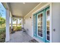 Inviting front porch with stylish blue door and ample space for outdoor seating at 13618 Briand Ave, Orlando, FL 32827