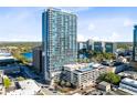 View of high-rise building featuring cityscape, lake views, pool, and convenient parking at 150 E Robinson St # 4A, Orlando, FL 32801