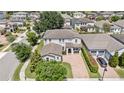 An aerial view shows the beautiful home, surrounding neighborhood, large driveway, and well-maintained landscaping at 16753 Gullfloss Ter, Winter Garden, FL 34787