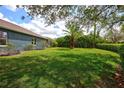 Expansive backyard featuring lush green lawn, mature landscaping, and privacy hedges at 1740 Cherry Ridge Dr, Lake Mary, FL 32746