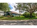 Landscaped home exterior showcasing manicured lawn, vibrant garden beds, and mature trees at 1740 Cherry Ridge Dr, Lake Mary, FL 32746