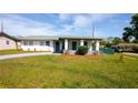 Inviting single-story home featuring a covered entryway, well-maintained lawn, and freshly painted driveway at 1831 Aaron Ave, Orlando, FL 32811