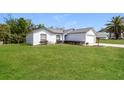 Inviting one-story home featuring lush green lawn and an attached two-car garage at 2081 Galveston Ave, Deltona, FL 32725