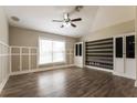 Spacious living room featuring vaulted ceilings, wood-look floors, and custom built-ins at 2081 Galveston Ave, Deltona, FL 32725