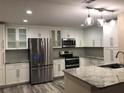 Modern kitchen featuring white cabinets, stainless steel appliances, and granite countertops, offering a sleek and functional space at 222 Georgetown Dr # C, Casselberry, FL 32707